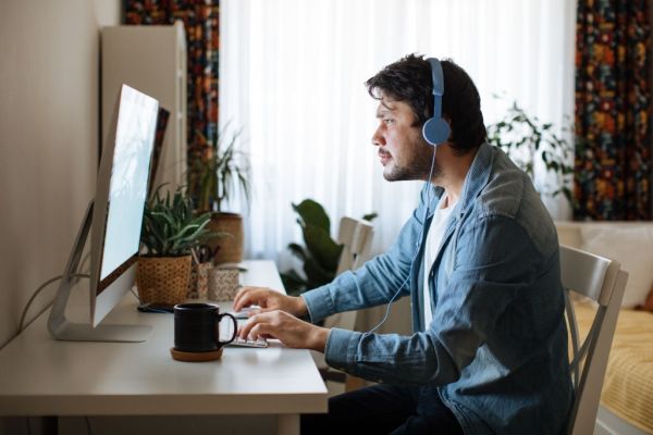 Young men playing video games with desktop